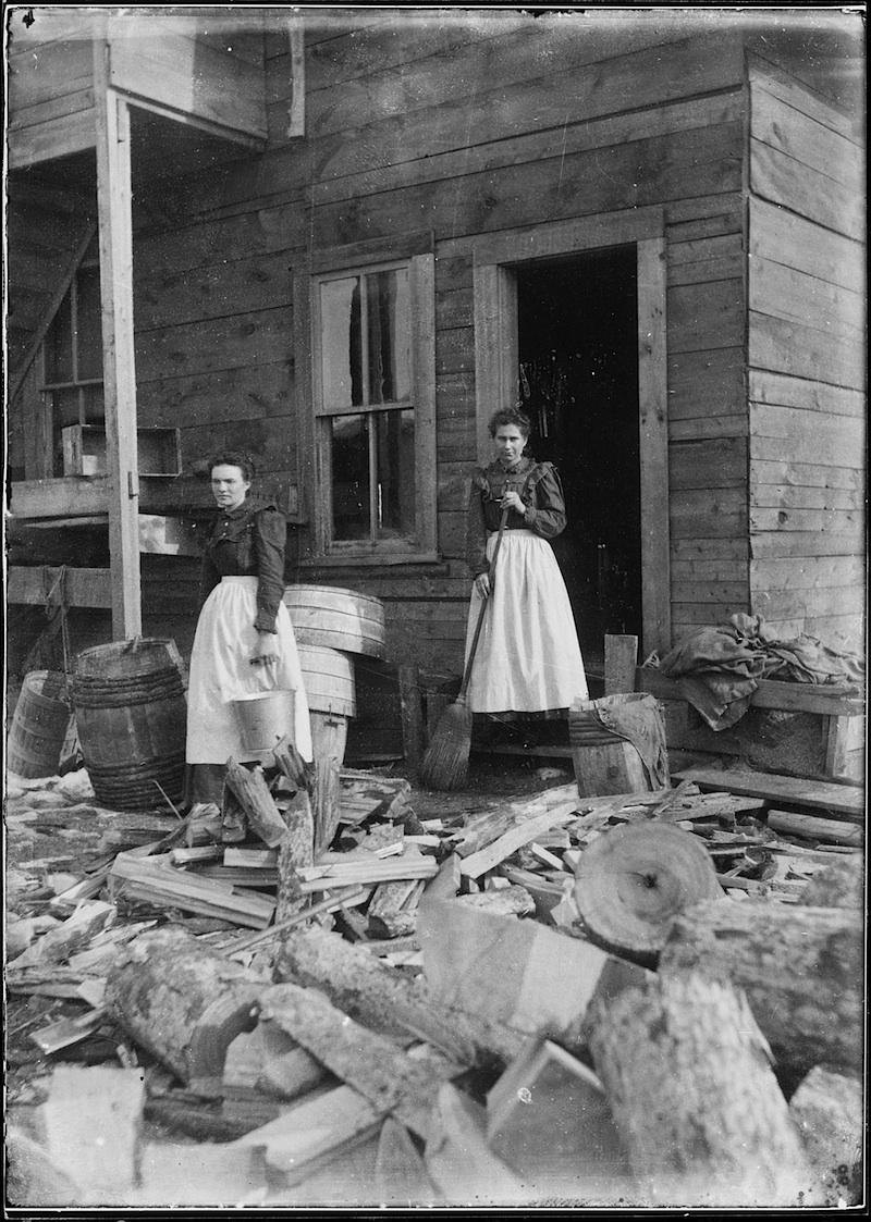 Two Women with a broom and a bucket