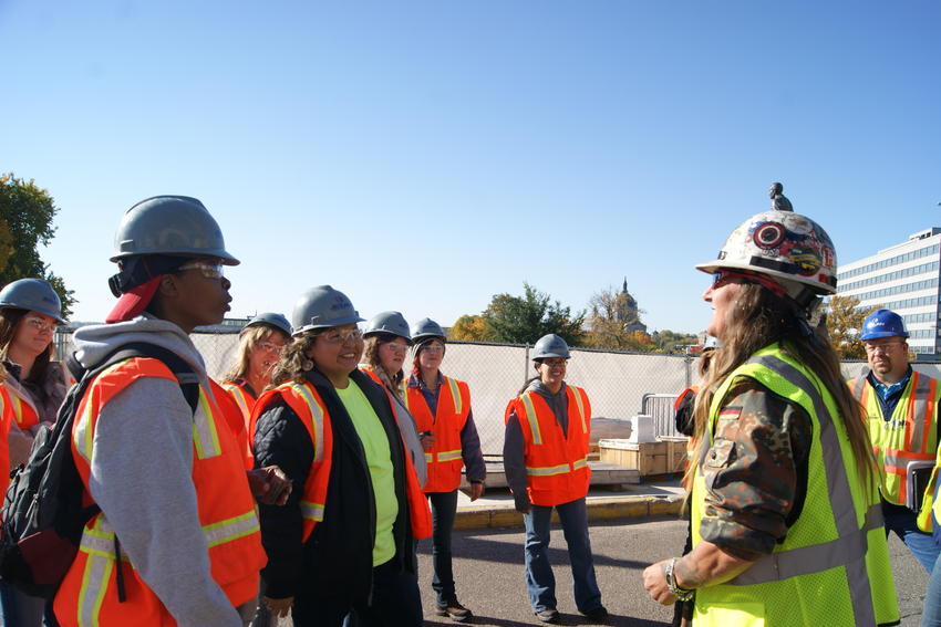 Worker briefs women during tour of Capitol restoration project