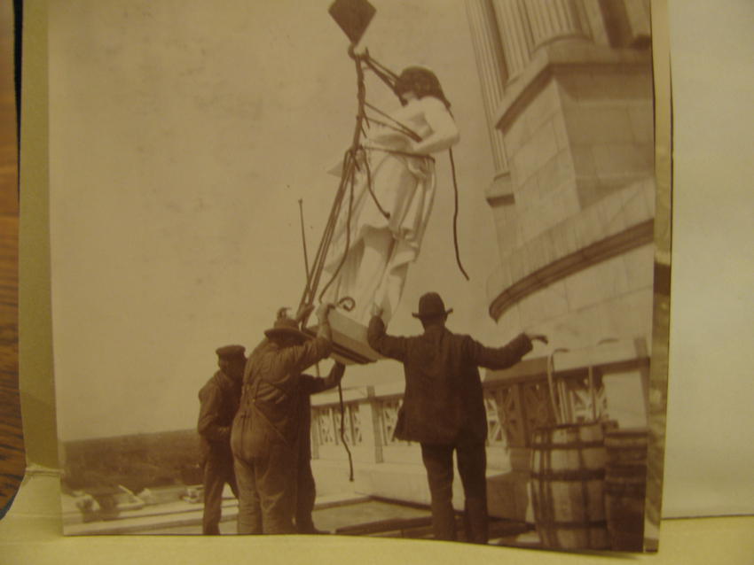 Setting one of six Virtues statues in place