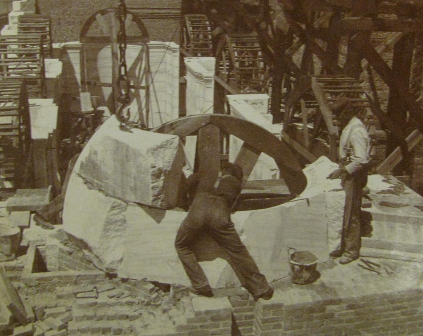 Workers setting rough stone in place, 1899-6-12