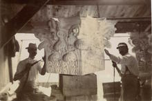 Stonecutters carving ornate capital